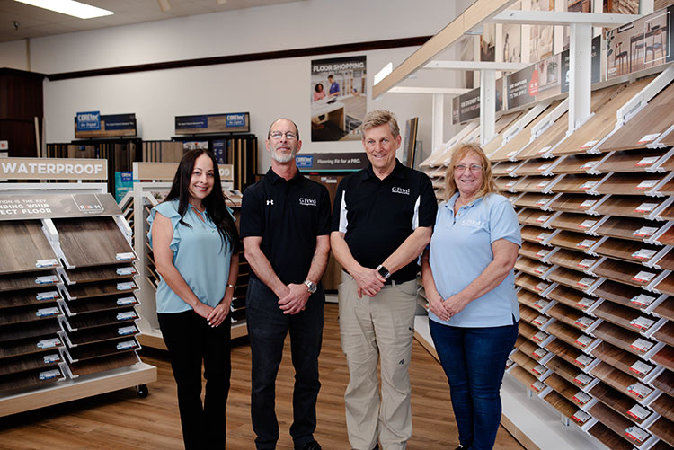 woman looking at flooring samples in a showroom with flooring expert